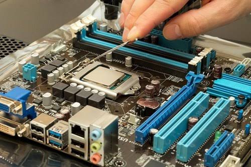 Engineer servicing a laptop